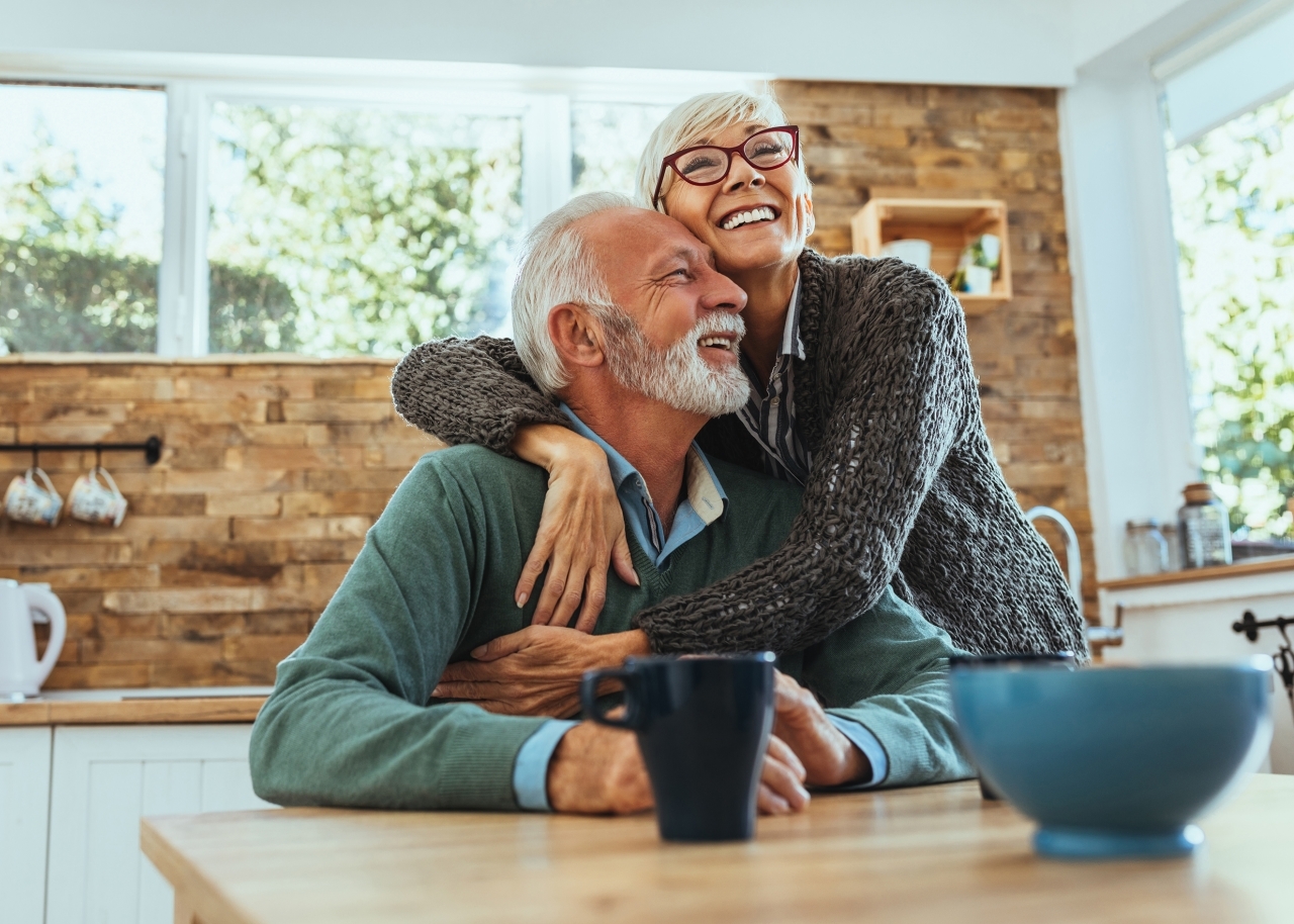 Couple hugging at table